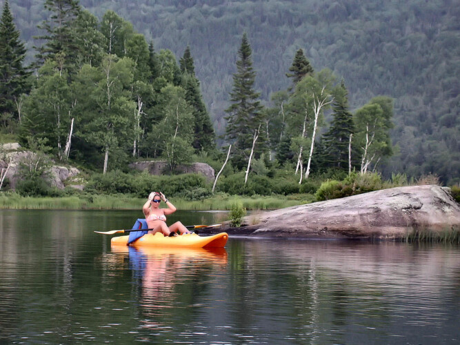 Femme en kayak sur le lac du Chalet en location Chalet sur le bord de l’eau à Lanaudière, chalet au bord de l'eau à Saint-Zénon